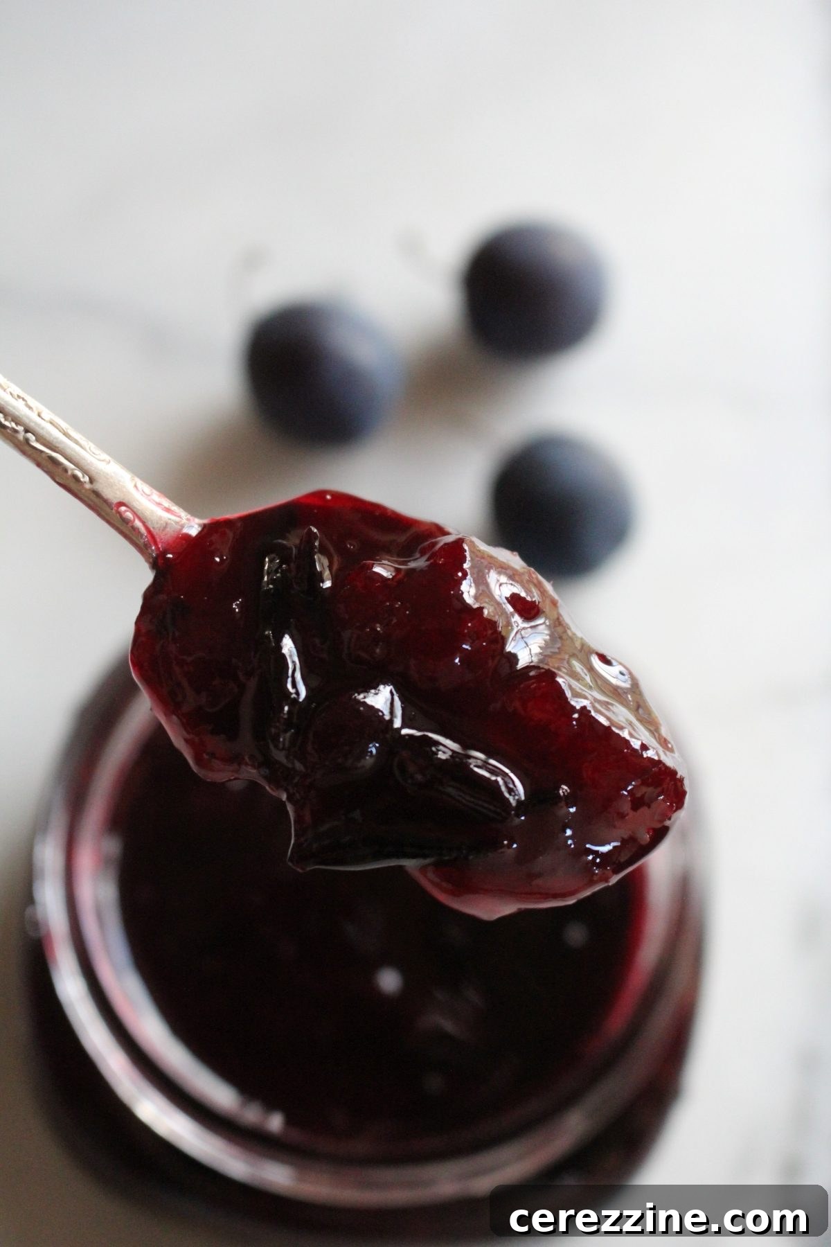Close-up of finished damson jam, showing the delightful texture with plum peels visible.