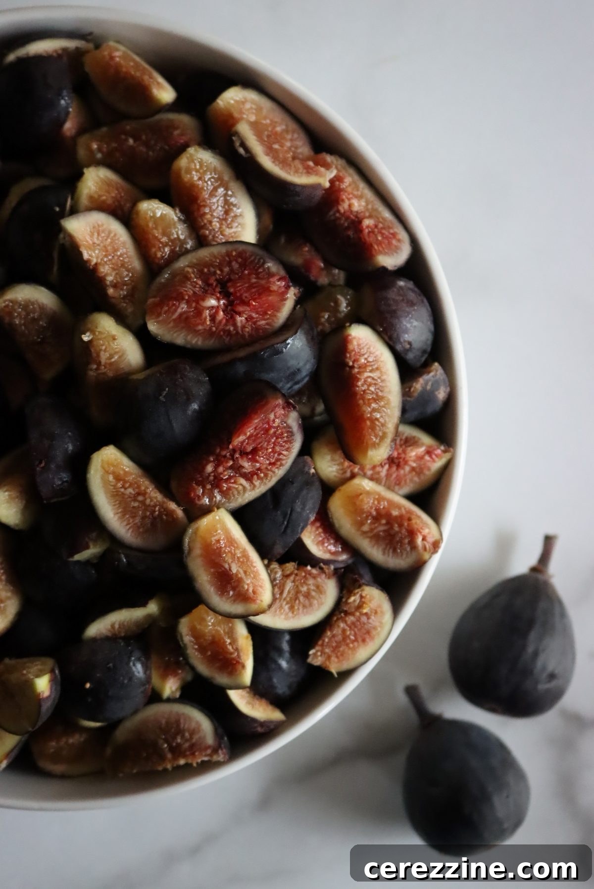 Fifty Varied Pickle Recipes From Asparagus To Zucchini 15 A glass jar filled with whole pickled figs, showcasing their rich color.