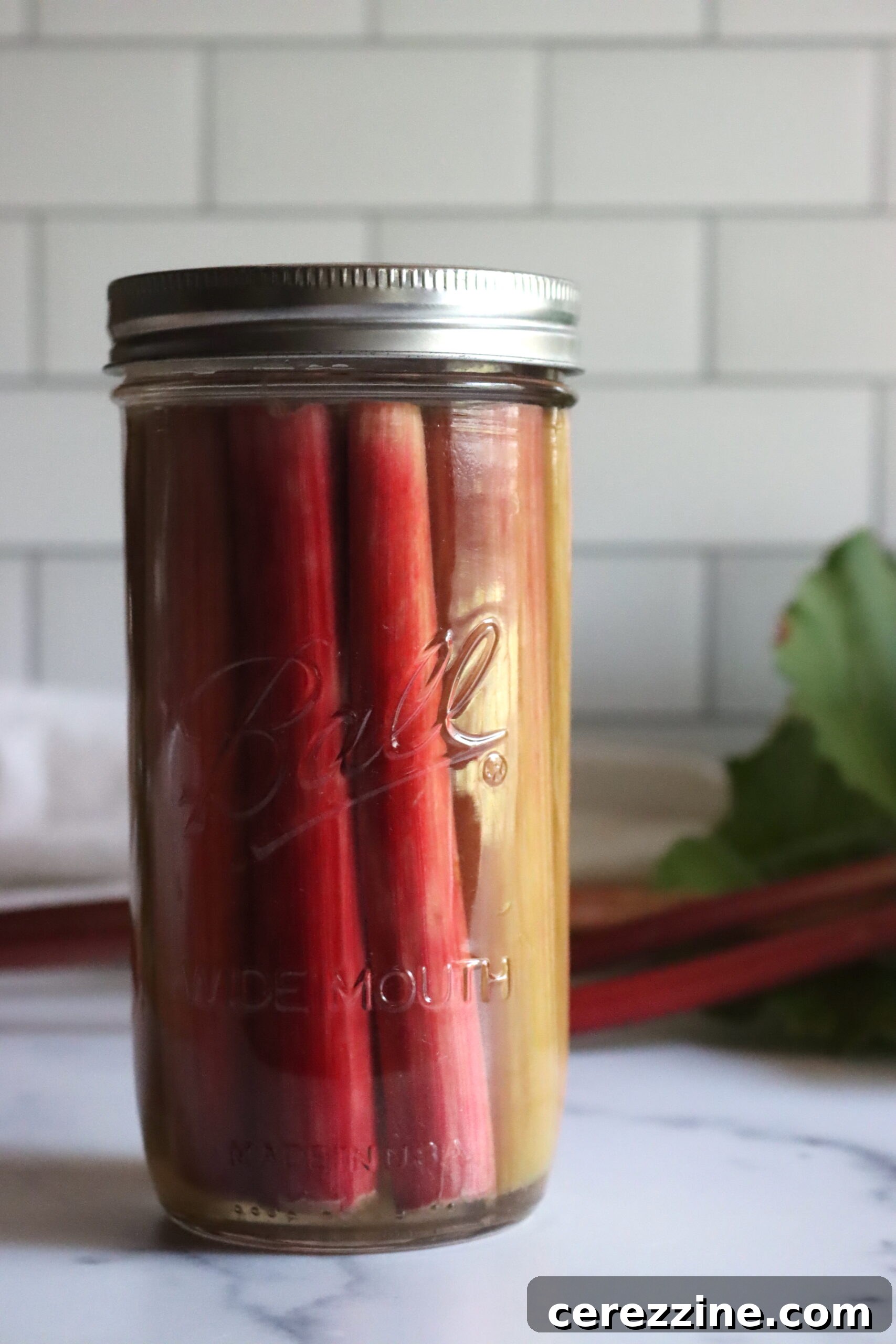 Fifty Varied Pickle Recipes From Asparagus To Zucchini 24 Slices of vibrantly colored pickled rhubarb in a glass jar.