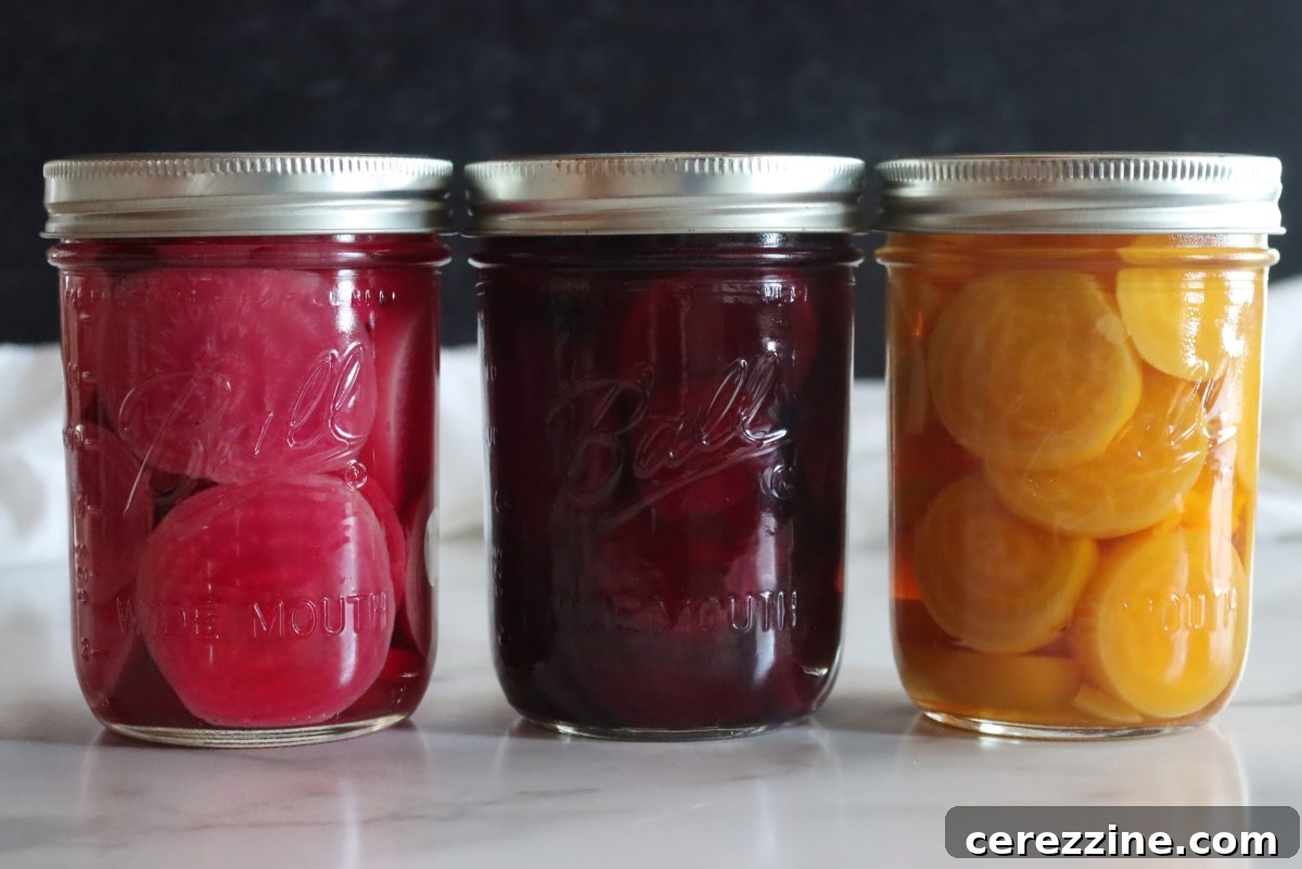 Fifty Varied Pickle Recipes From Asparagus To Zucchini 6 Jars of vividly colored pickled beets, showcasing their rich red hue.
