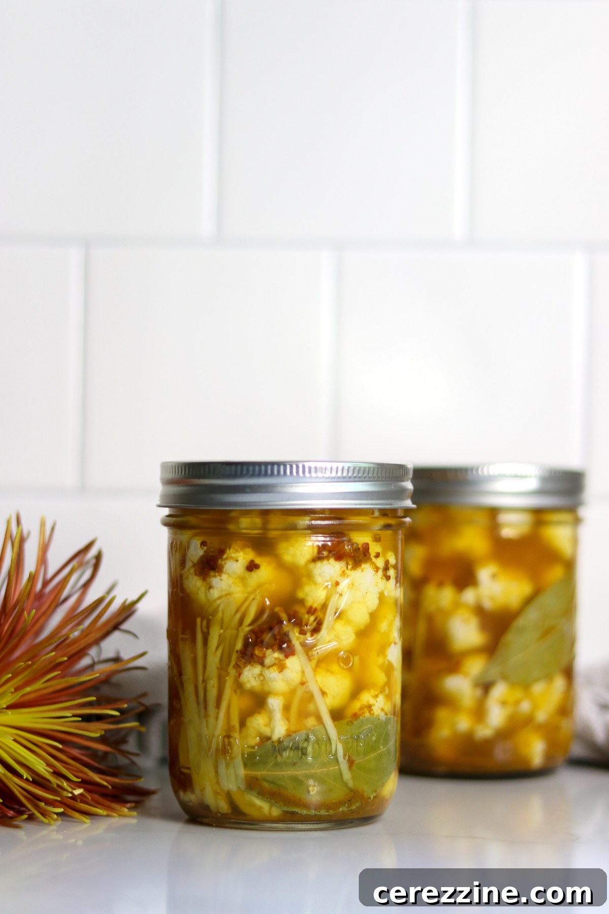 Fifty Varied Pickle Recipes From Asparagus To Zucchini 10 Close-up of a jar filled with pickled cauliflower florets and spices.