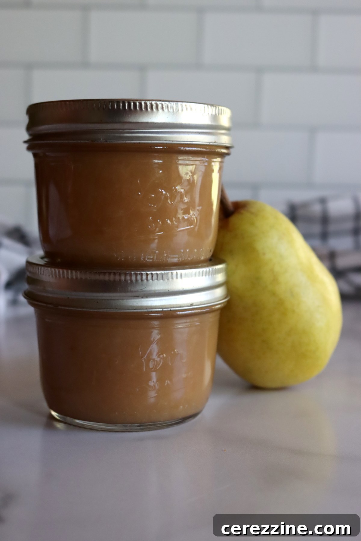 Homemade Fruit Butters: Apple, Pear, Peach and Beyond 10 Home canned pear butter, neatly sealed in jars.