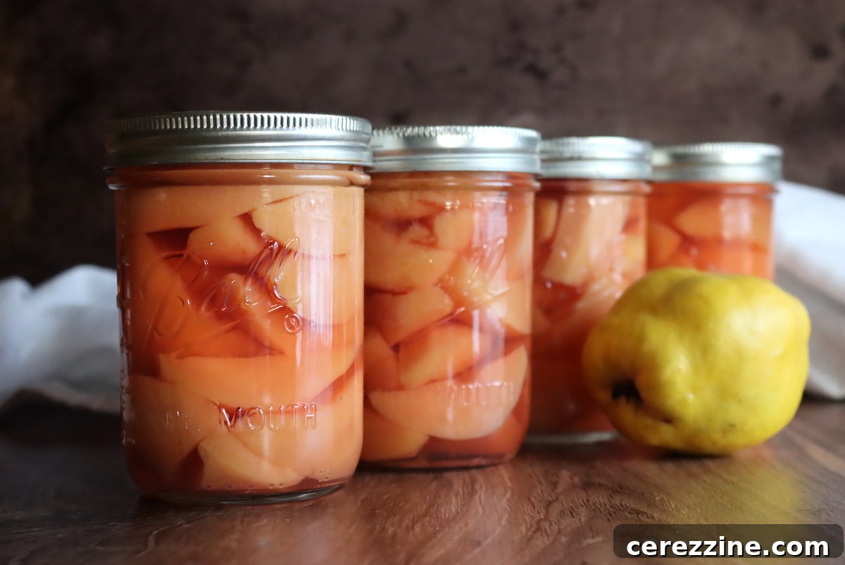 Finished jars of canned quince on a cooling rack