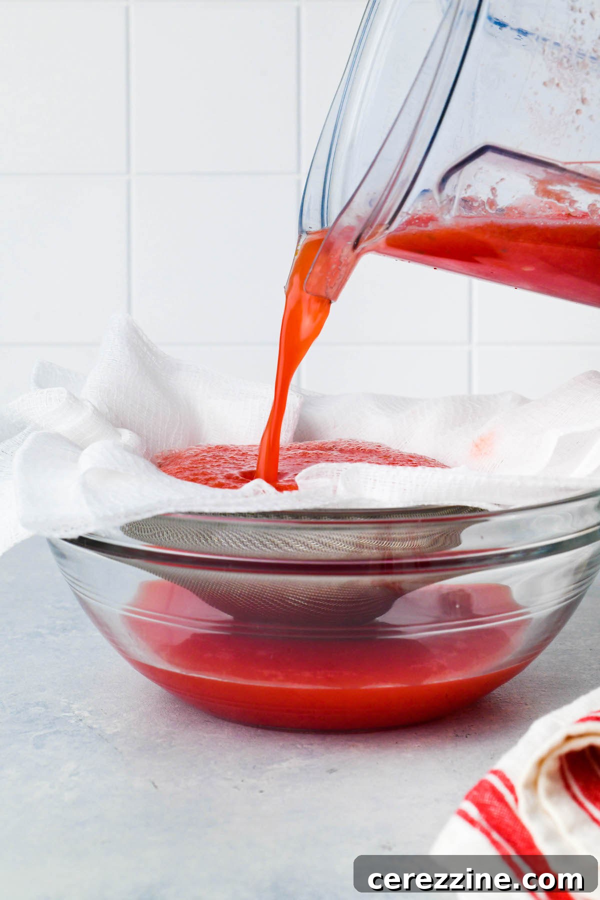 Straining watermelon juice through cheesecloth