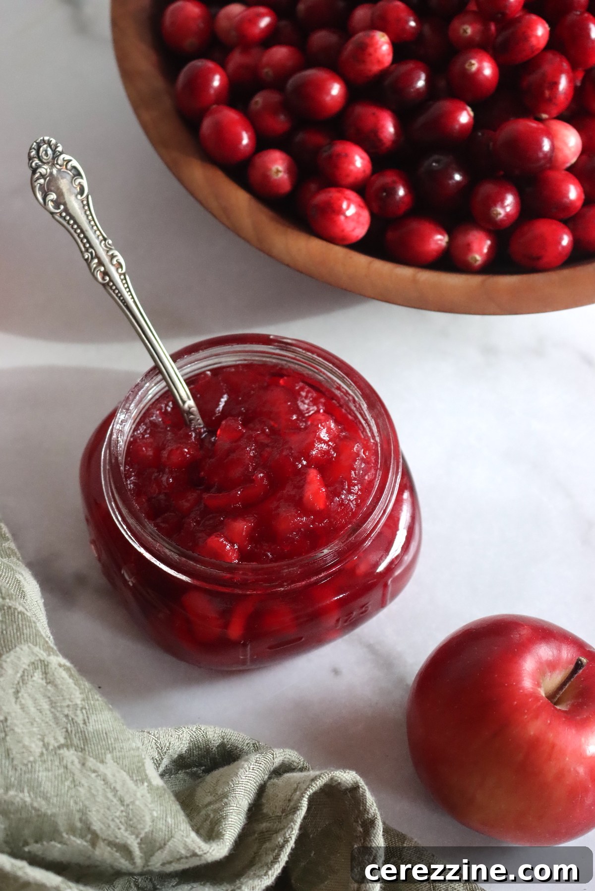 Tart Cranberry Apple Preserve 4 A pot of Cranberry Apple Jam simmering on the stove, showing its rich color and texture.