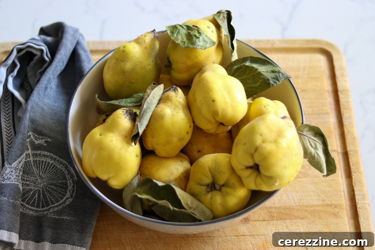 A rustic wooden bowl brimming with fresh, ripe golden-yellow quinces, ready for jam making.