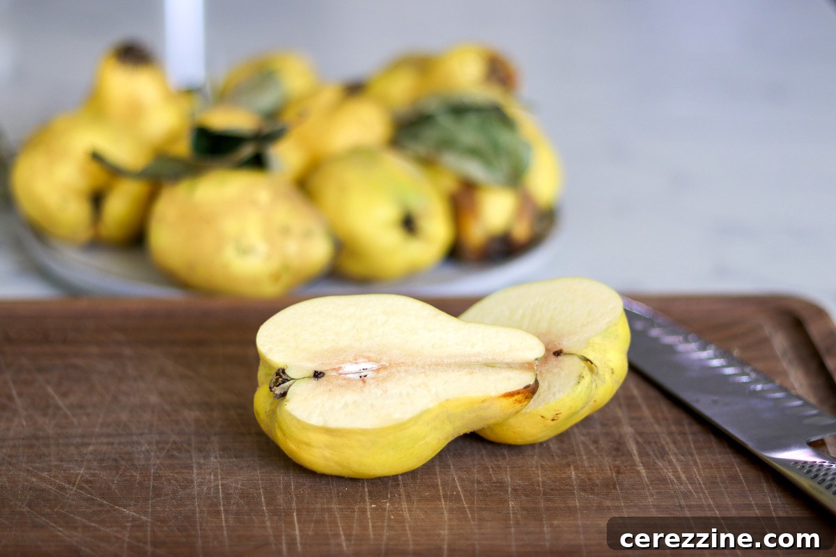 Freshly sliced quince pieces, exposing the light flesh, ready for cooking into jam.