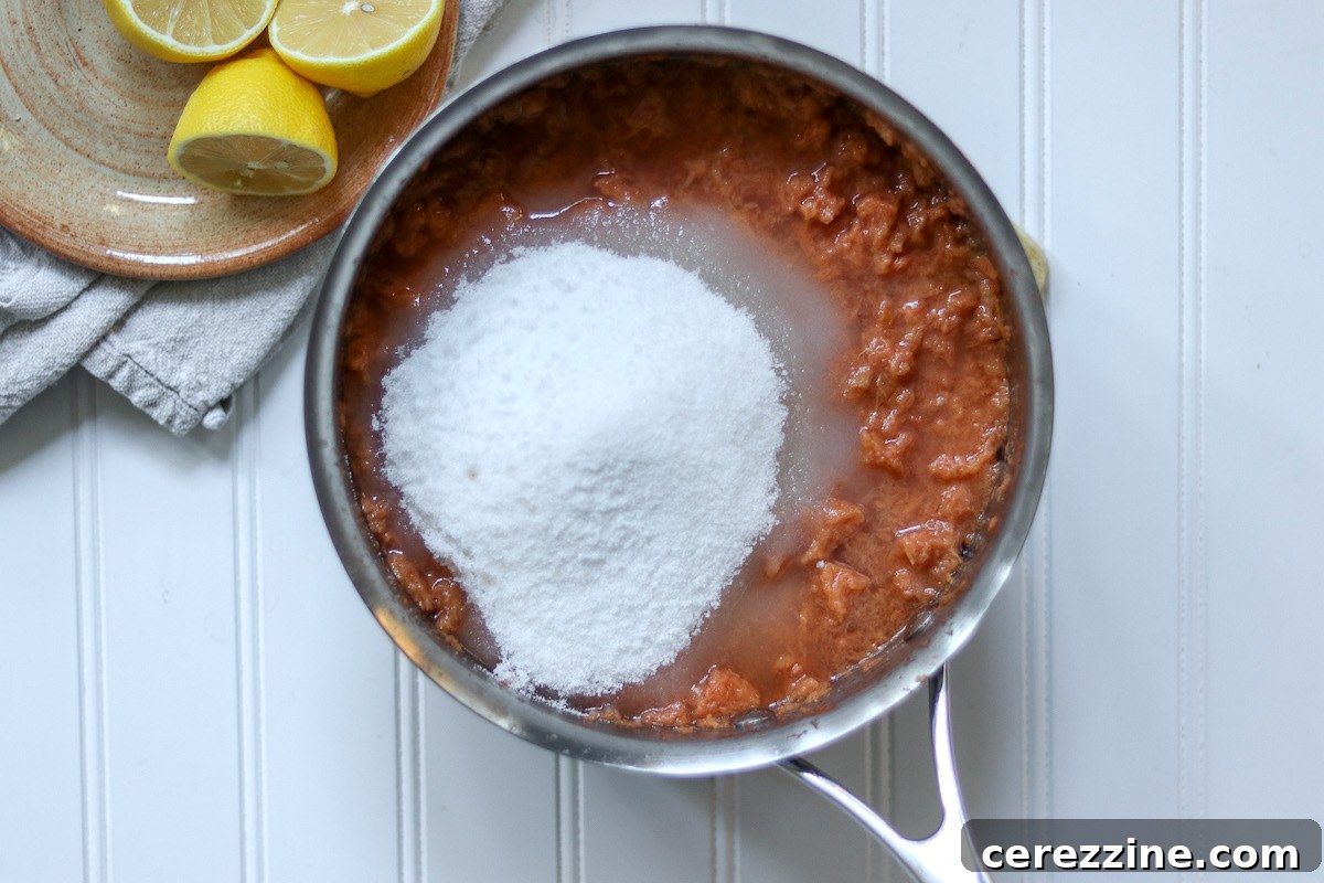 Quince jam mixture bubbling in a pot on the stovetop, stirred by a wooden spoon.