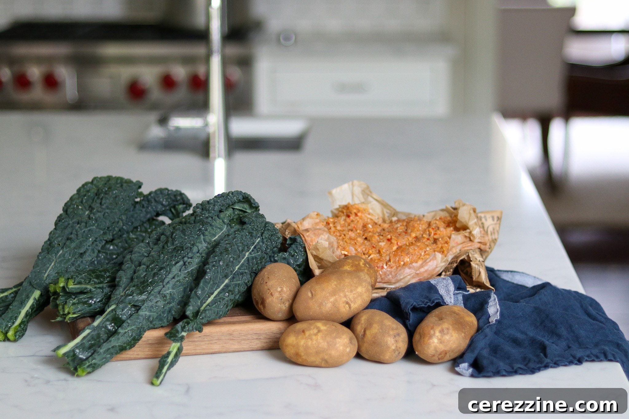 Ingredients for Sausage Potato Kale Soup laid out