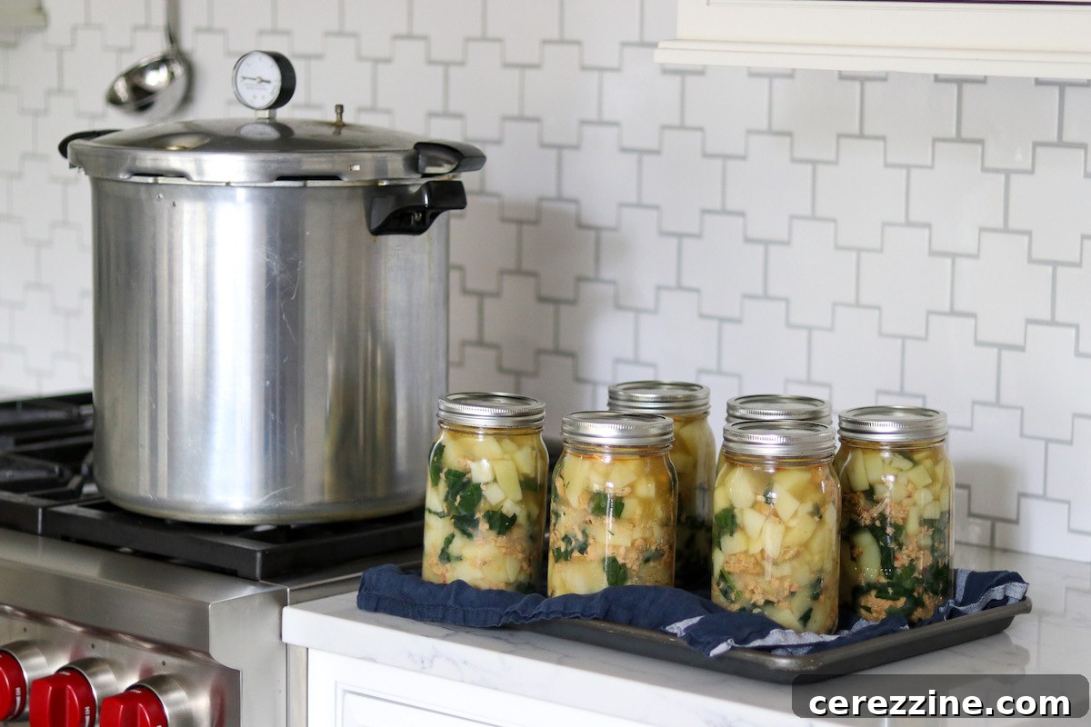Canning Sausage Potato and Kale Soup in mason jars