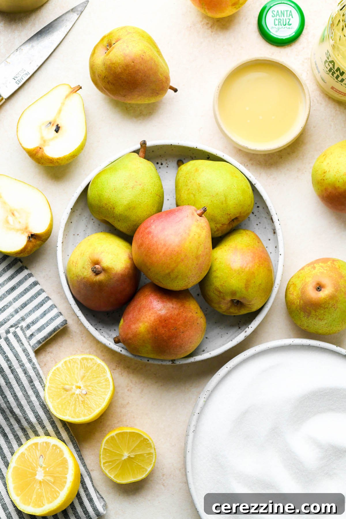 Sun Kissed Pear Jam 4 Ingredients for pear jam laid out on a table: pears, sugar, and lemon juice.