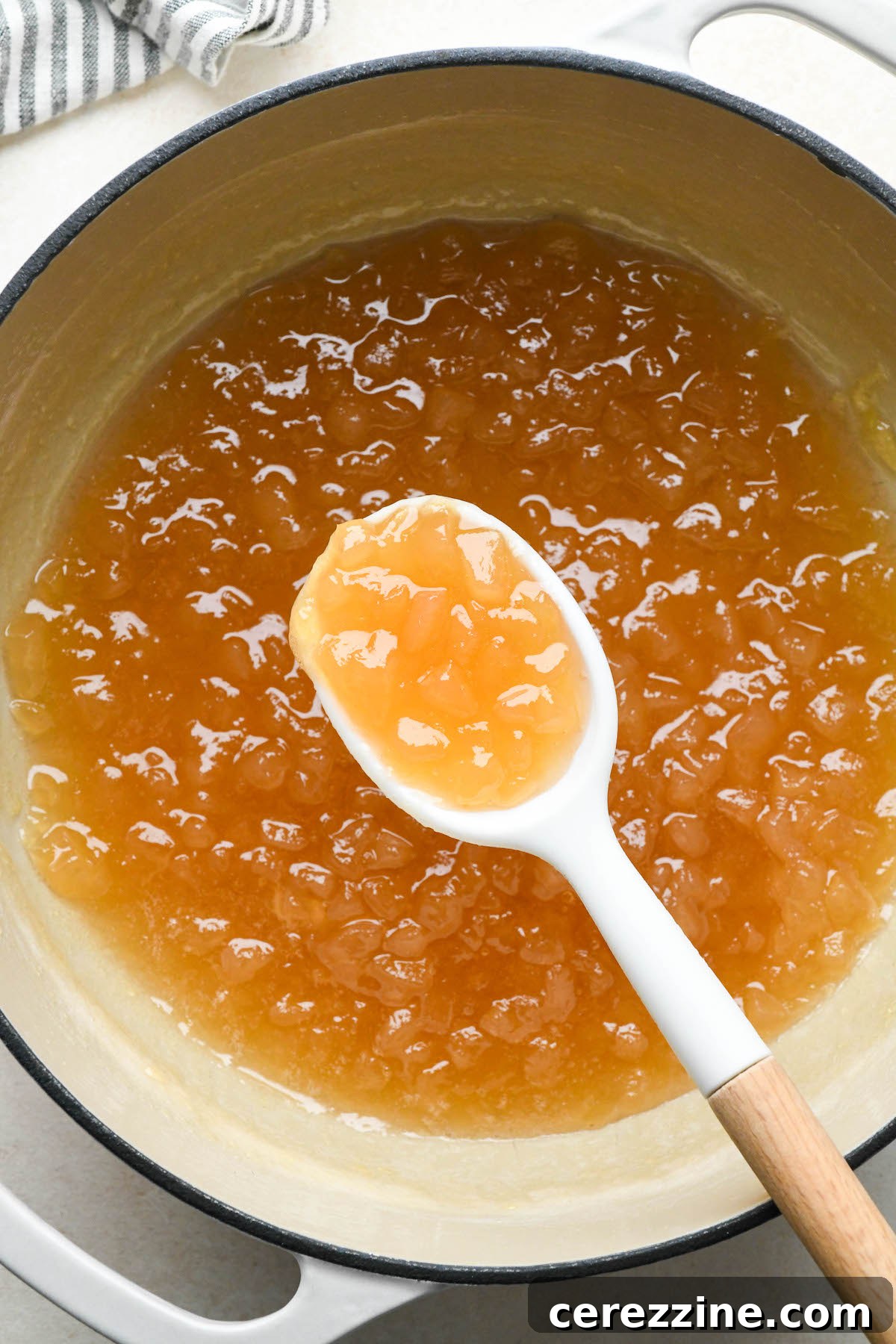 Sun Kissed Pear Jam 9 Pear jam simmering in a saucepan on the stove.