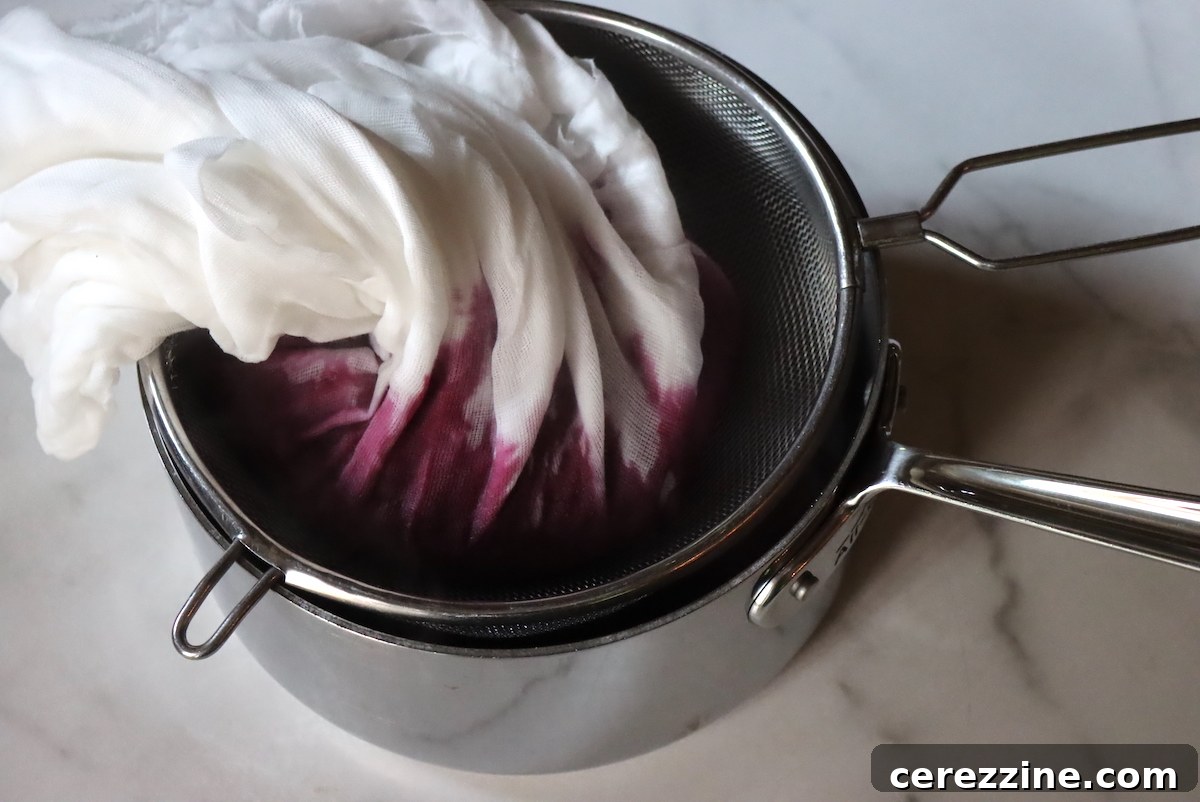 Straining Saskatoon Jelly Through Cheesecloth