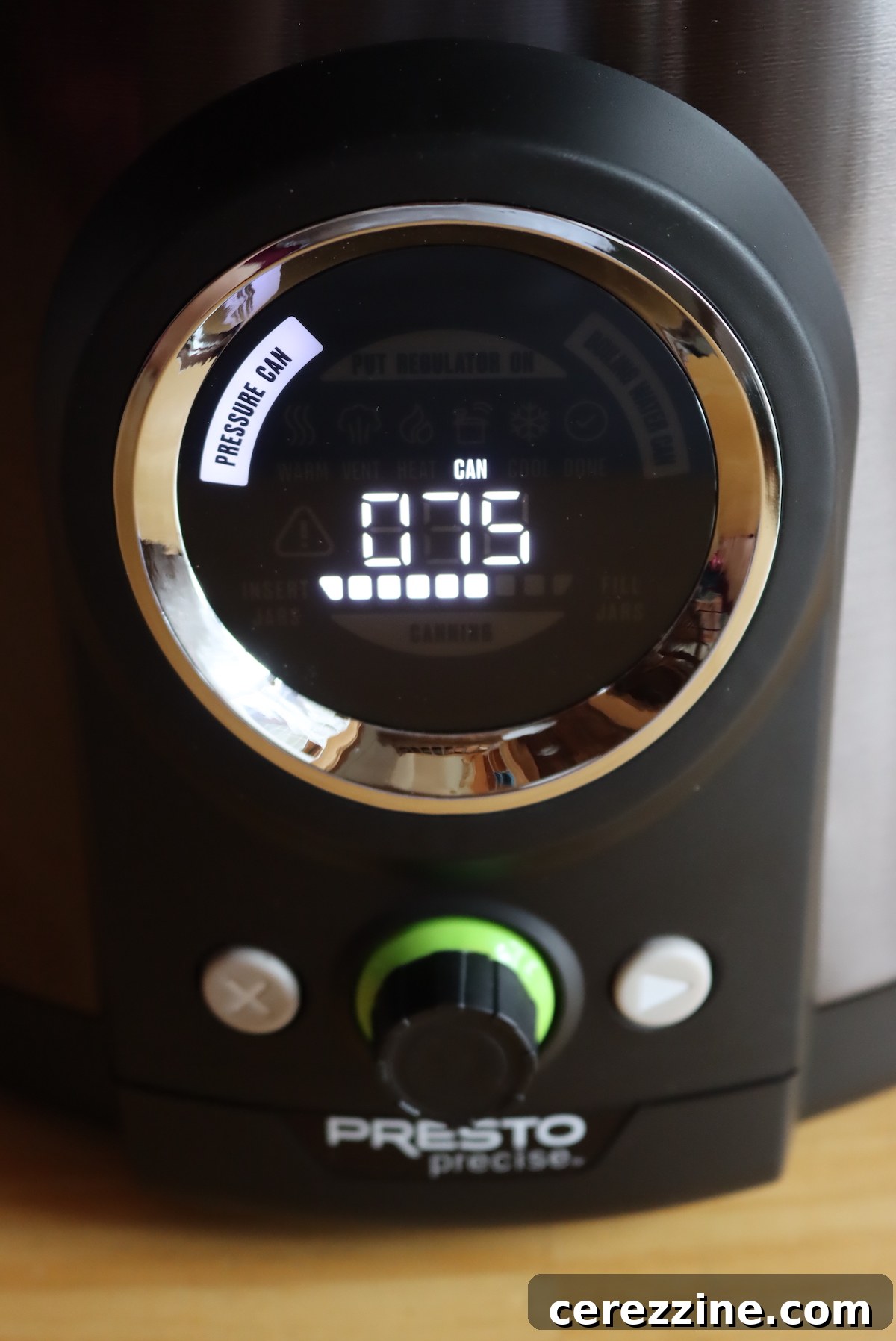Digital pressure canner display showing the countdown timer for the canning process.