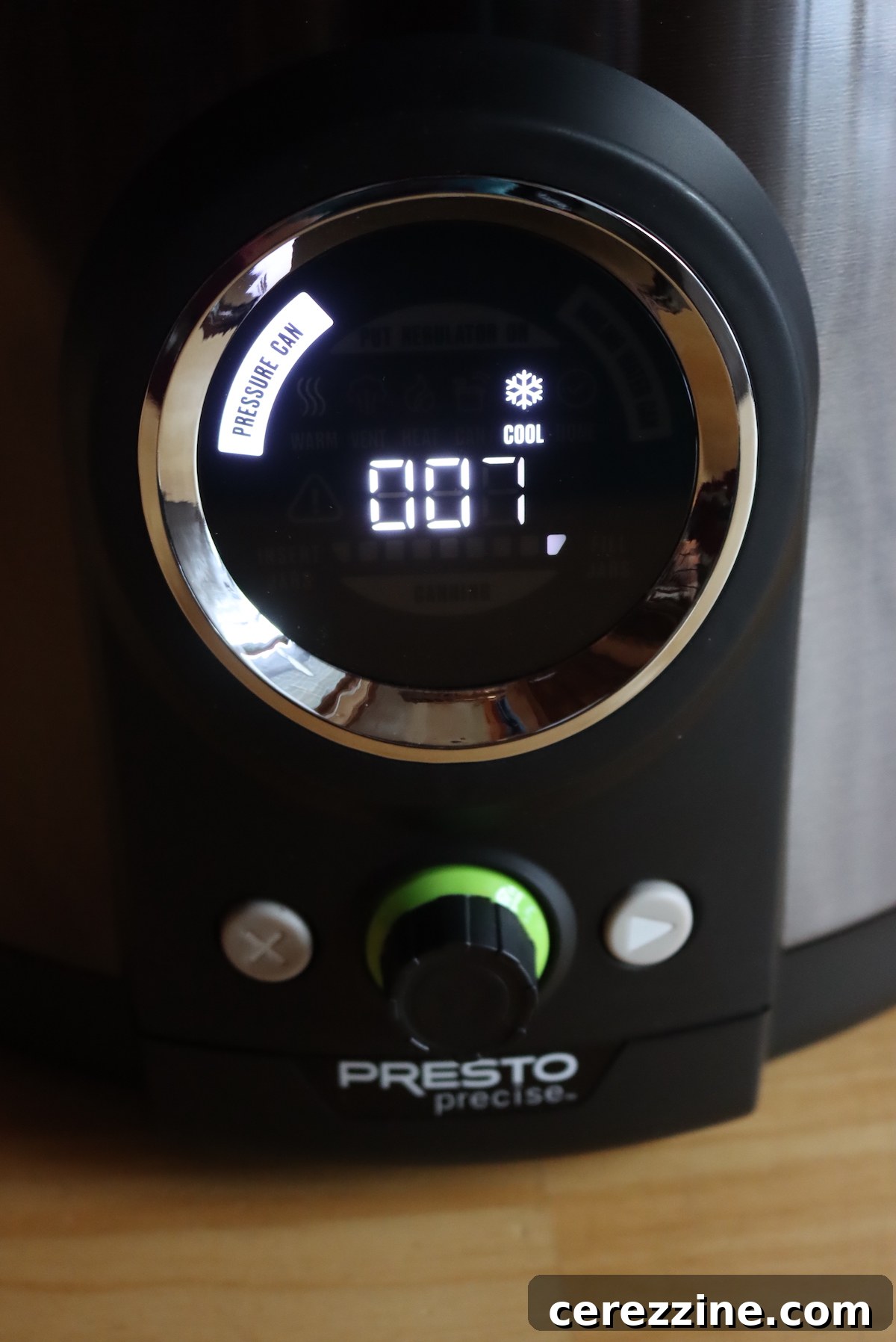 Digital pressure canner display showing 'Cooling' with a countdown timer during depressurization.