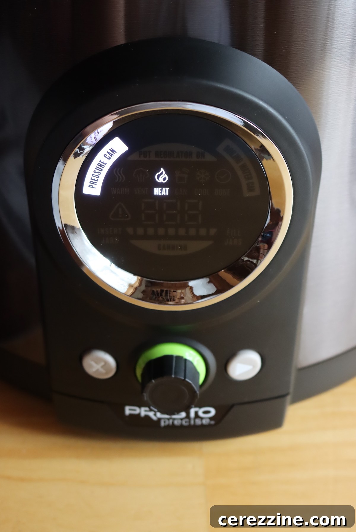 Digital pressure canner display indicating 'Preheating' before the venting process begins.