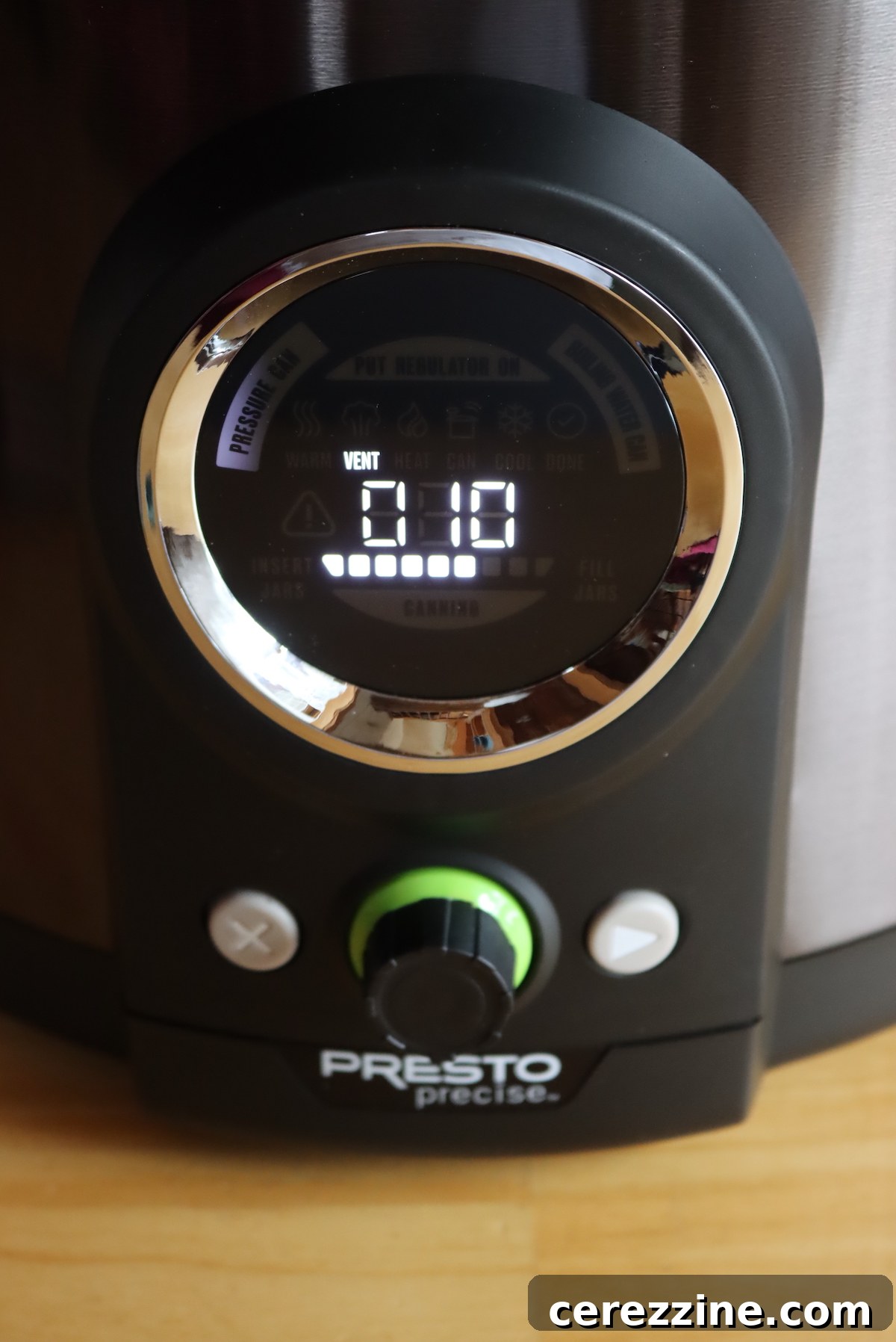 Electric pressure canner actively venting steam during its 10-minute countdown phase.