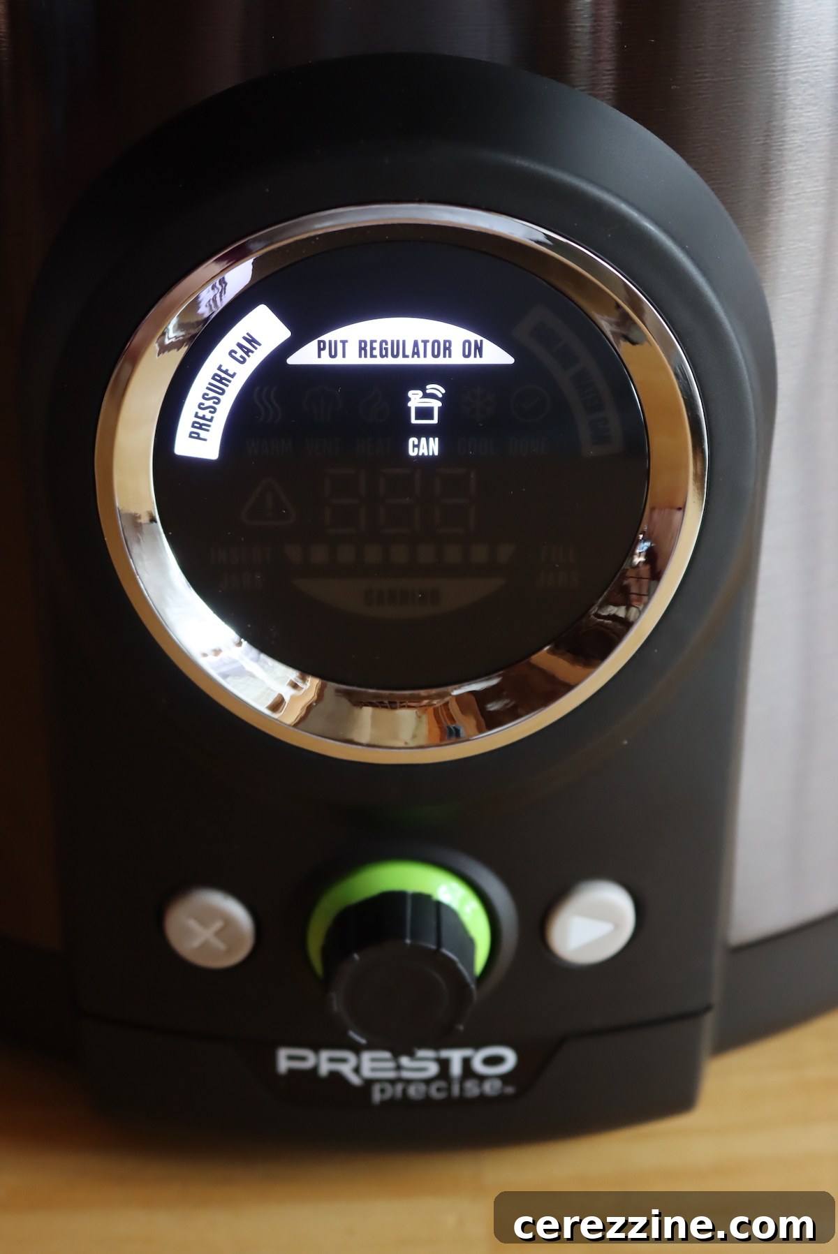 Instructions on the electric pressure canner display to attach the pressure regulator for canning.