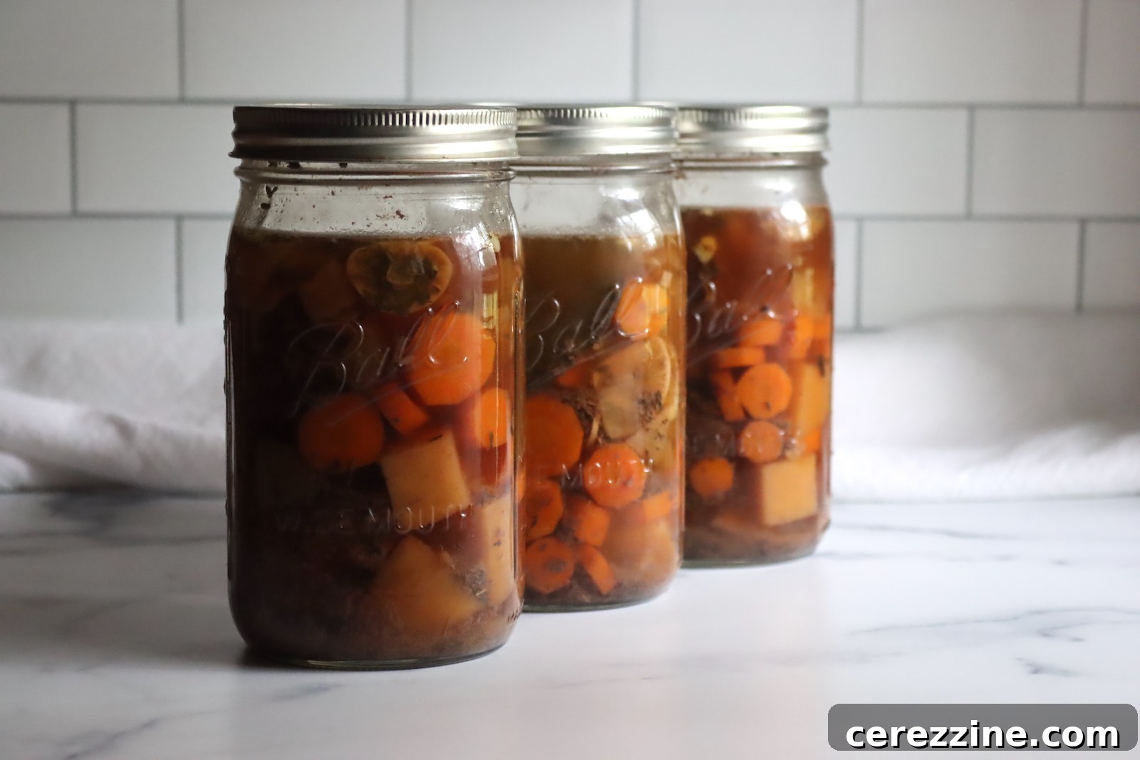 Pot Roast in Jars: A Canning Guide 6 Freshly canned pot roast in jars cooling on a rack after successful pressure canning