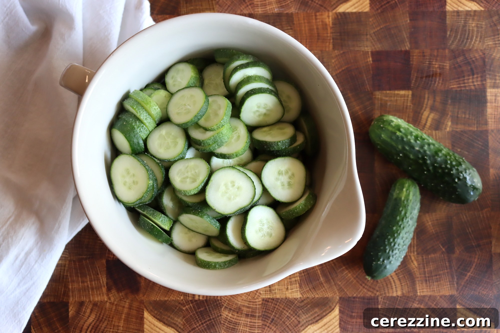 Old Fashioned Super Crispy Cucumber Pickles 5 Lime Pickle Cucumber - Freshly sliced cucumbers soaking in a lime solution, preparing for the pickling process.