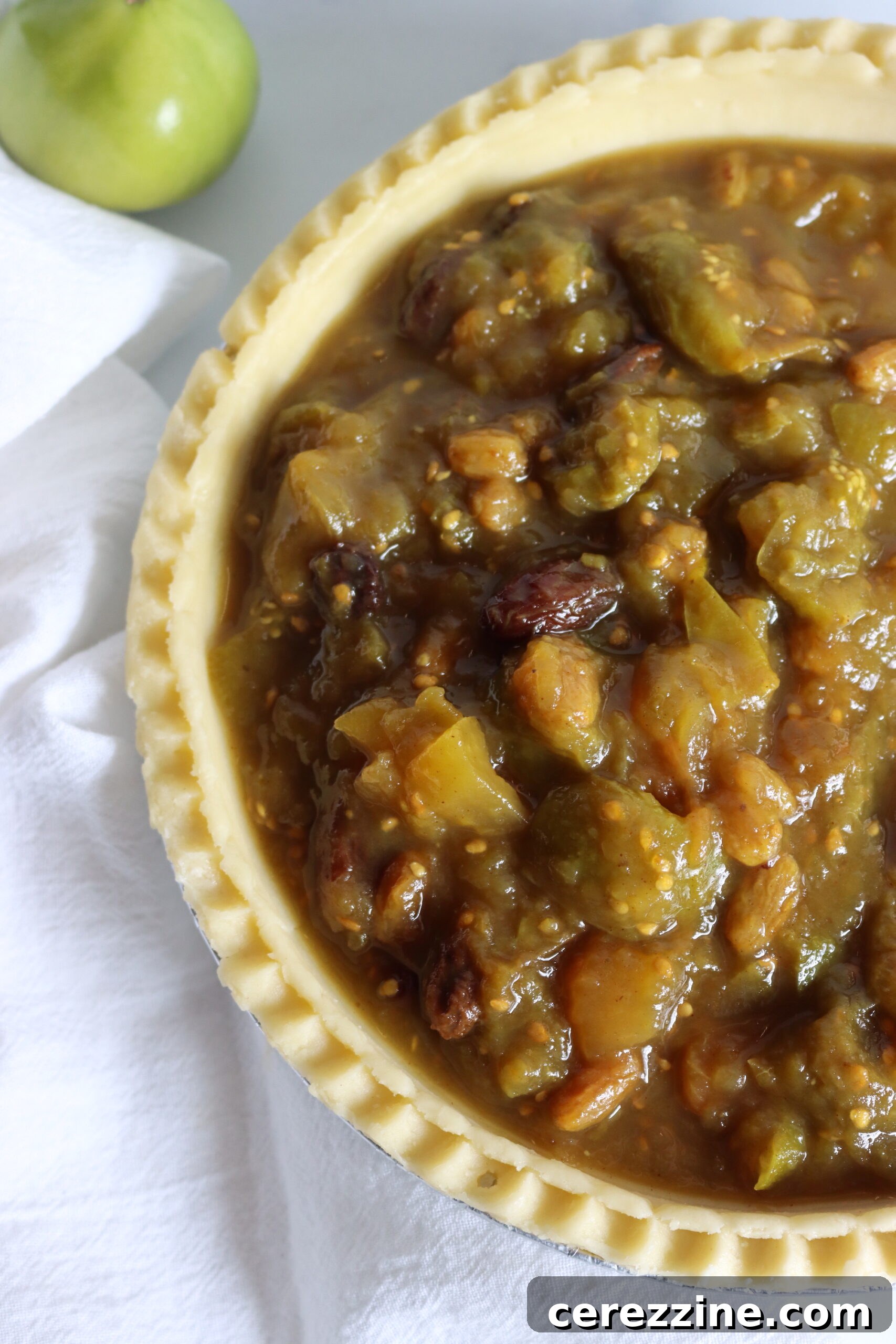 Preparing Green Tomato Pie Filling - Close-up of chopped green tomatoes and other ingredients simmering in a pot.