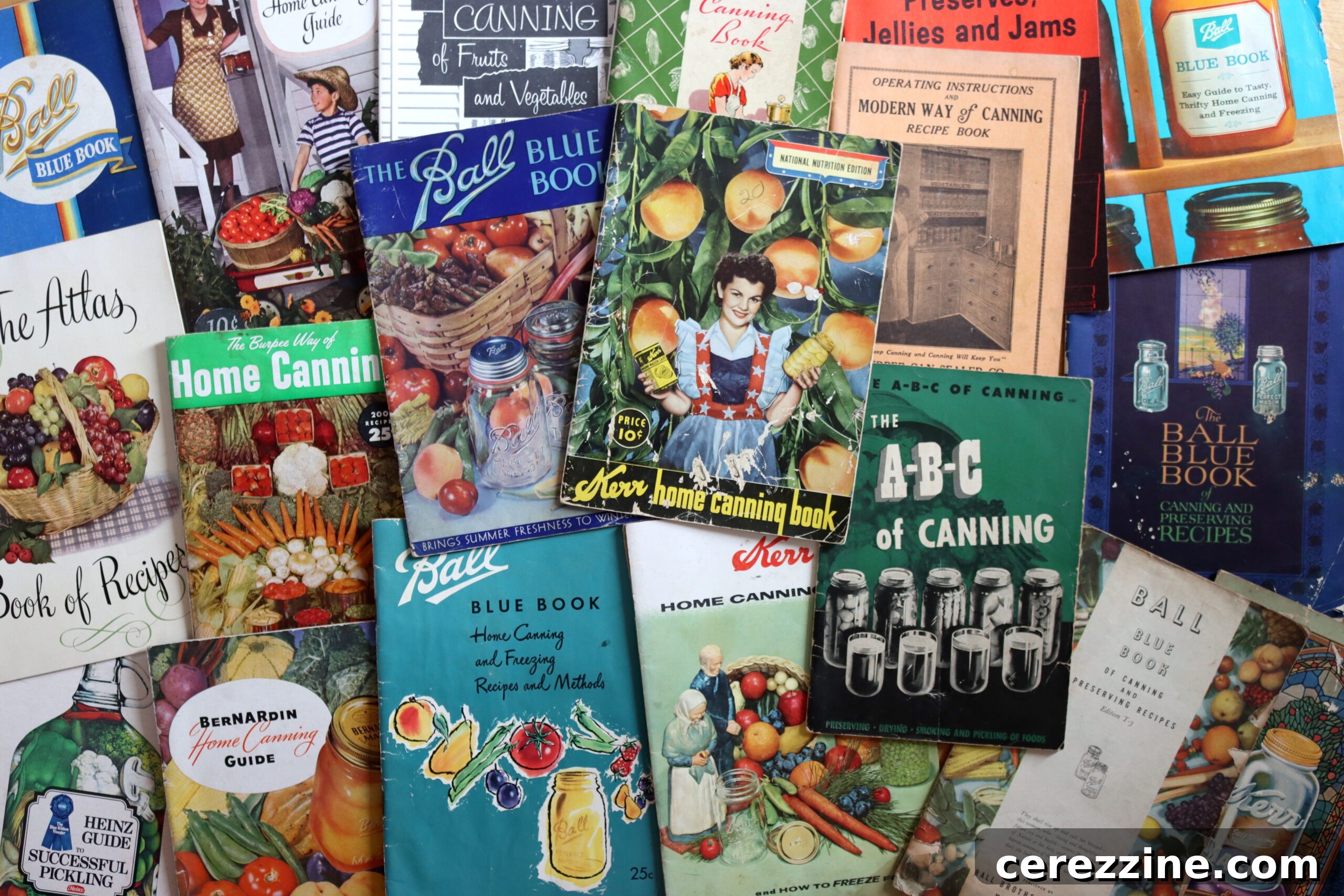 A collection of vintage canning books from different eras.