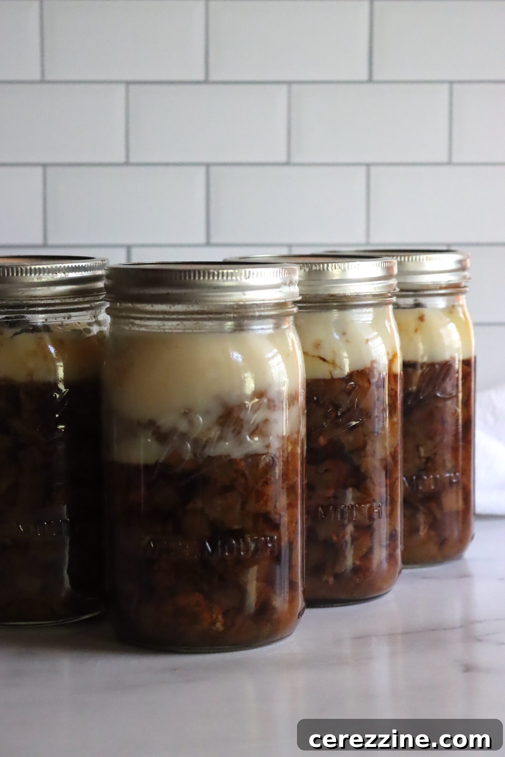 Sealed jars of canned lamb on a cooling rack