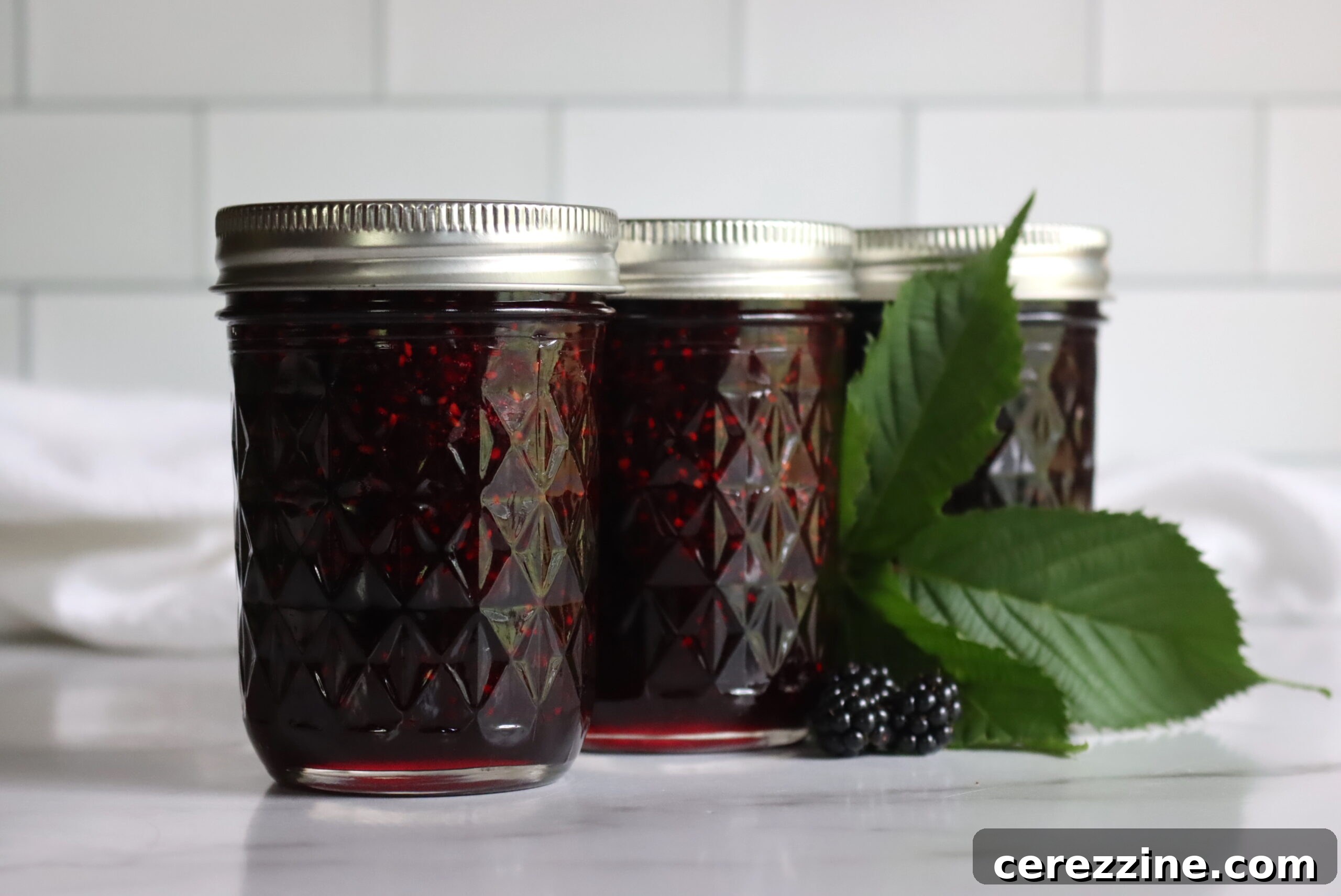 Close-up of fresh blackberries, sugar, and lemon, ready for jam making.