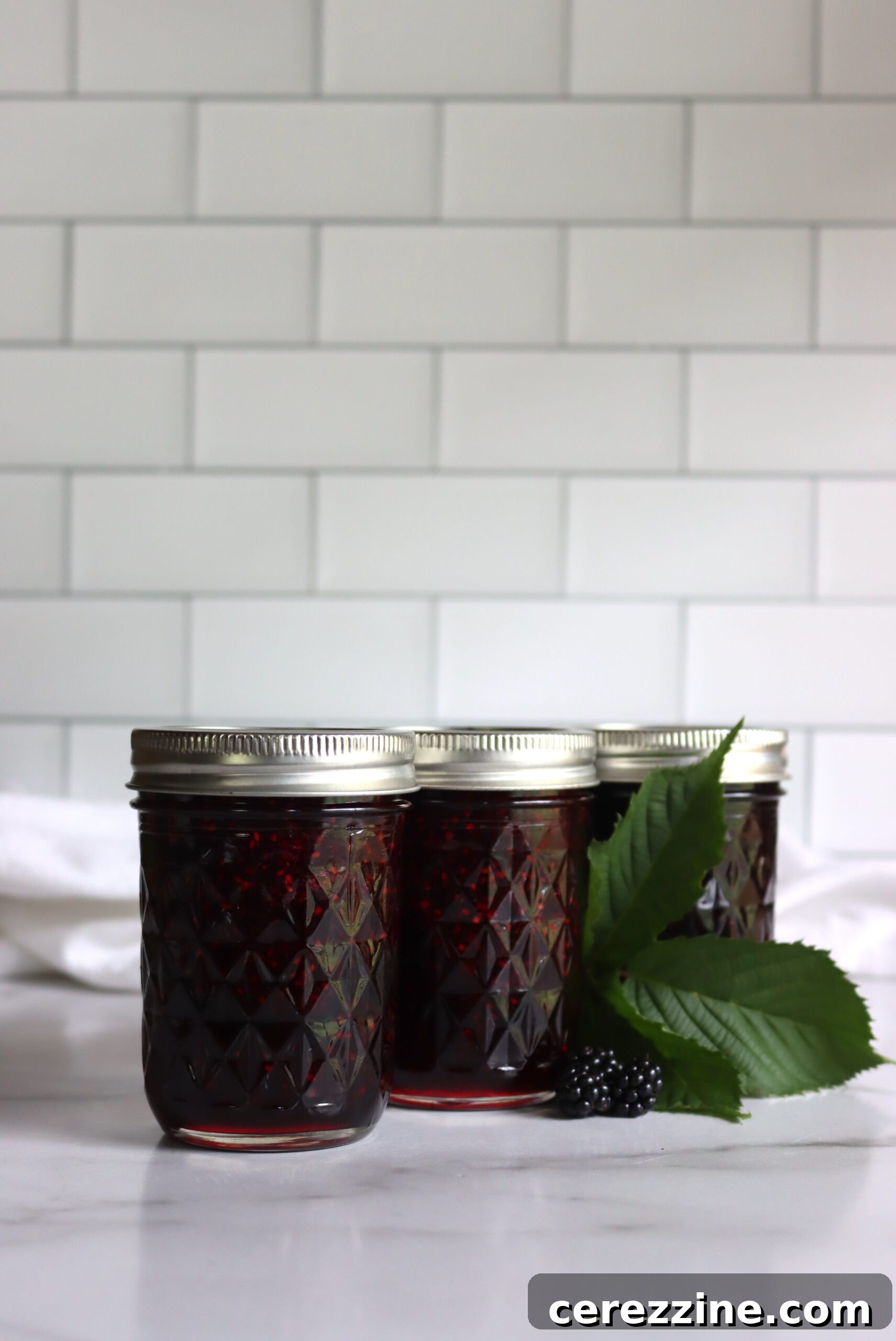Finished blackberry jam in sealed jars, ready for storage.