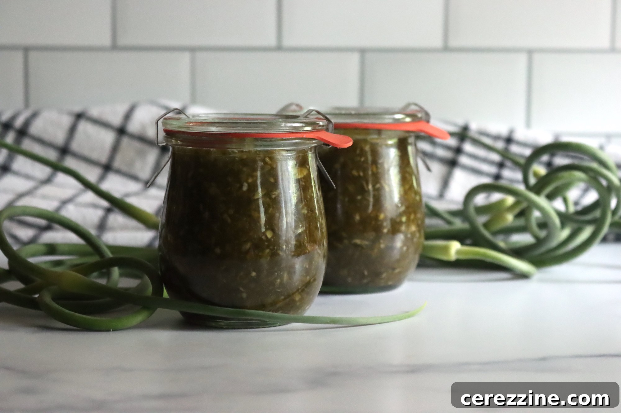 Multiple Jars of Homemade Garlic Scape Jam Lined Up
