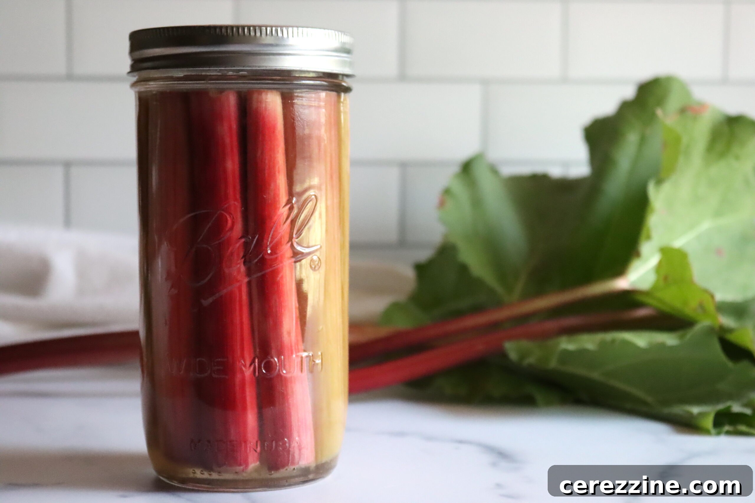 Sweet-Sour Rhubarb Preserve 5 Jars of Sweet Pickled Rhubarb on a Cooling Rack