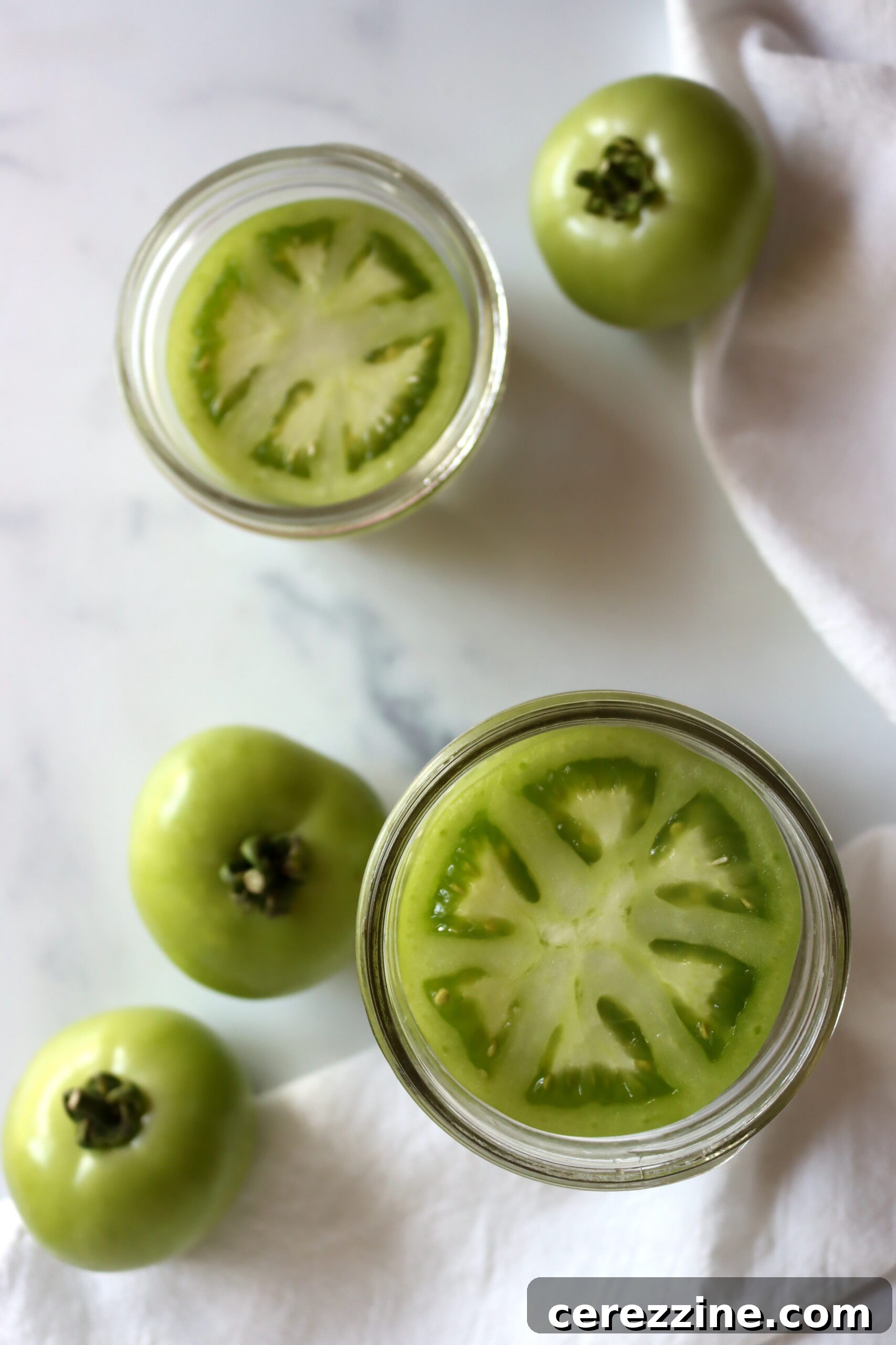 Preserving Tangy Green Tomatoes 4 Green Tomato Slices in a Canning Jar