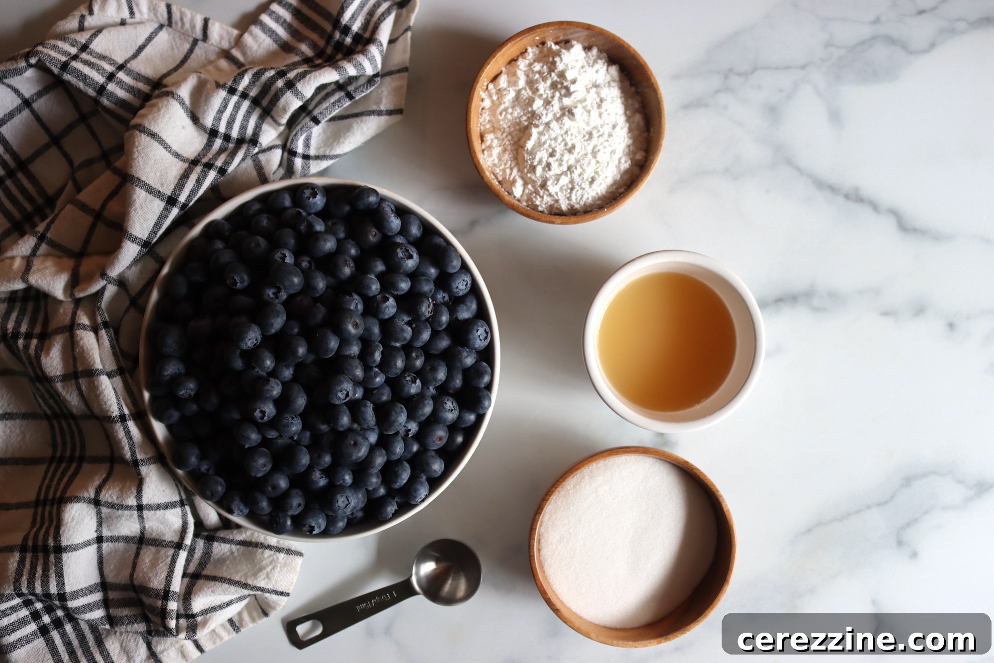 Crafting Perfect Homemade Blueberry Pie Filling for Canning 3 Ingredients for homemade blueberry pie filling, including fresh blueberries, sugar, Clear Jel, and lemon juice.