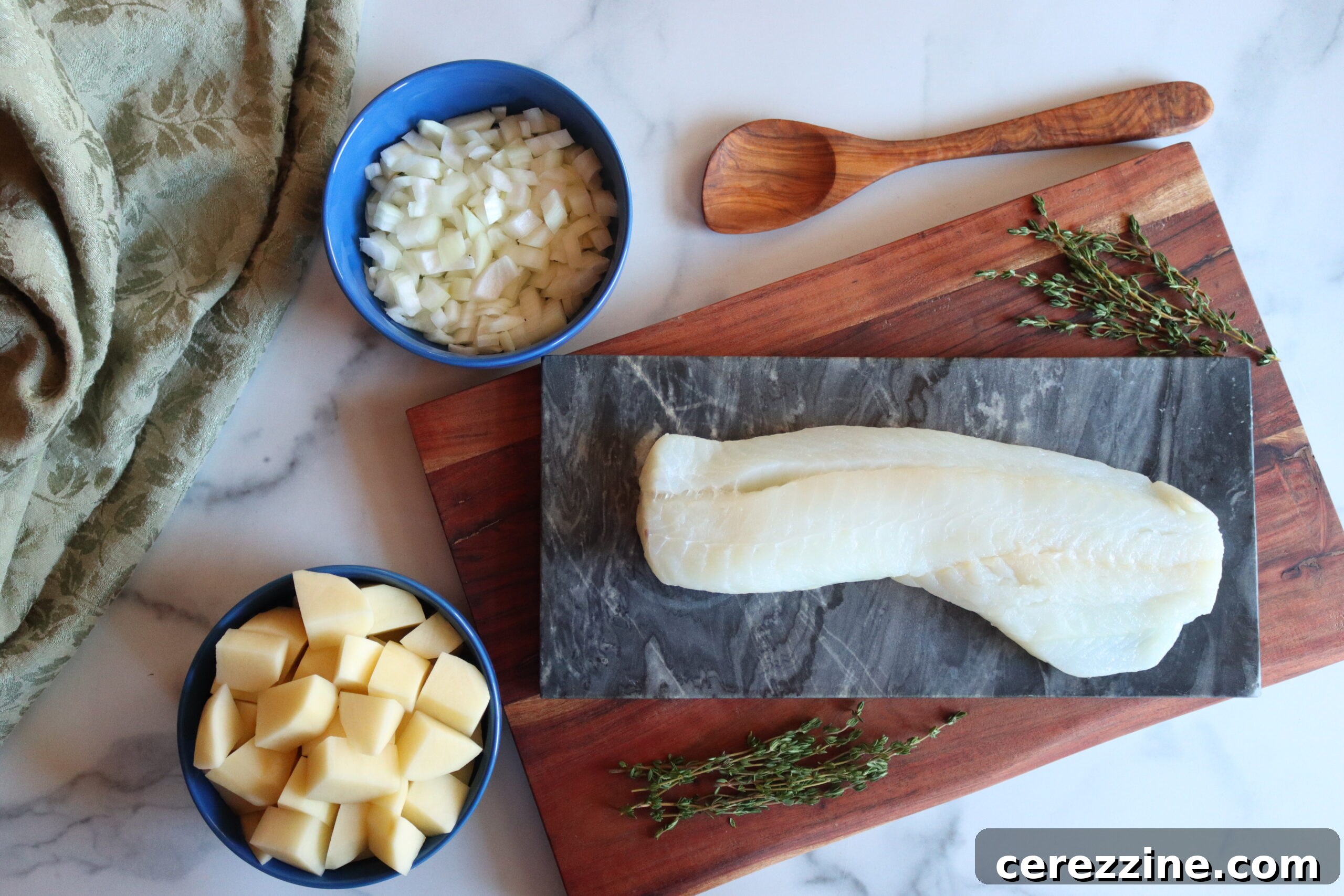 Fish Chowder Ingredients - A collection of fresh vegetables, fish fillets, and seasonings laid out for canning fish chowder.