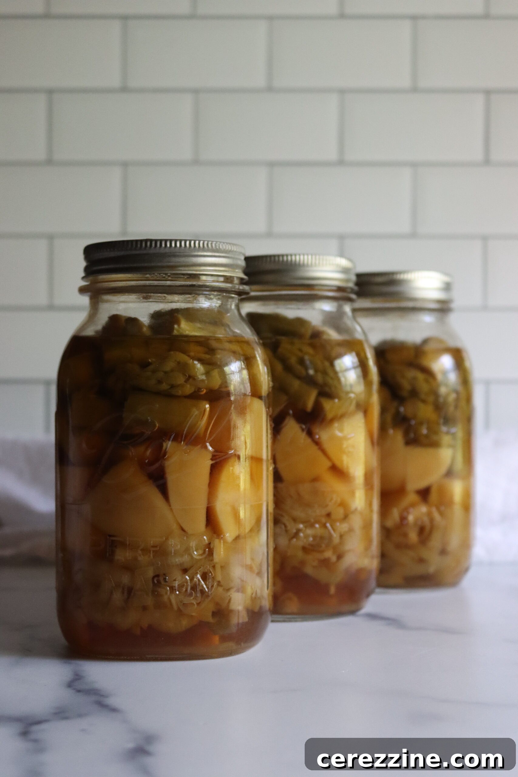 Canned Asparagus Potato Leek soup jars cooling on a rack after pressure canning.