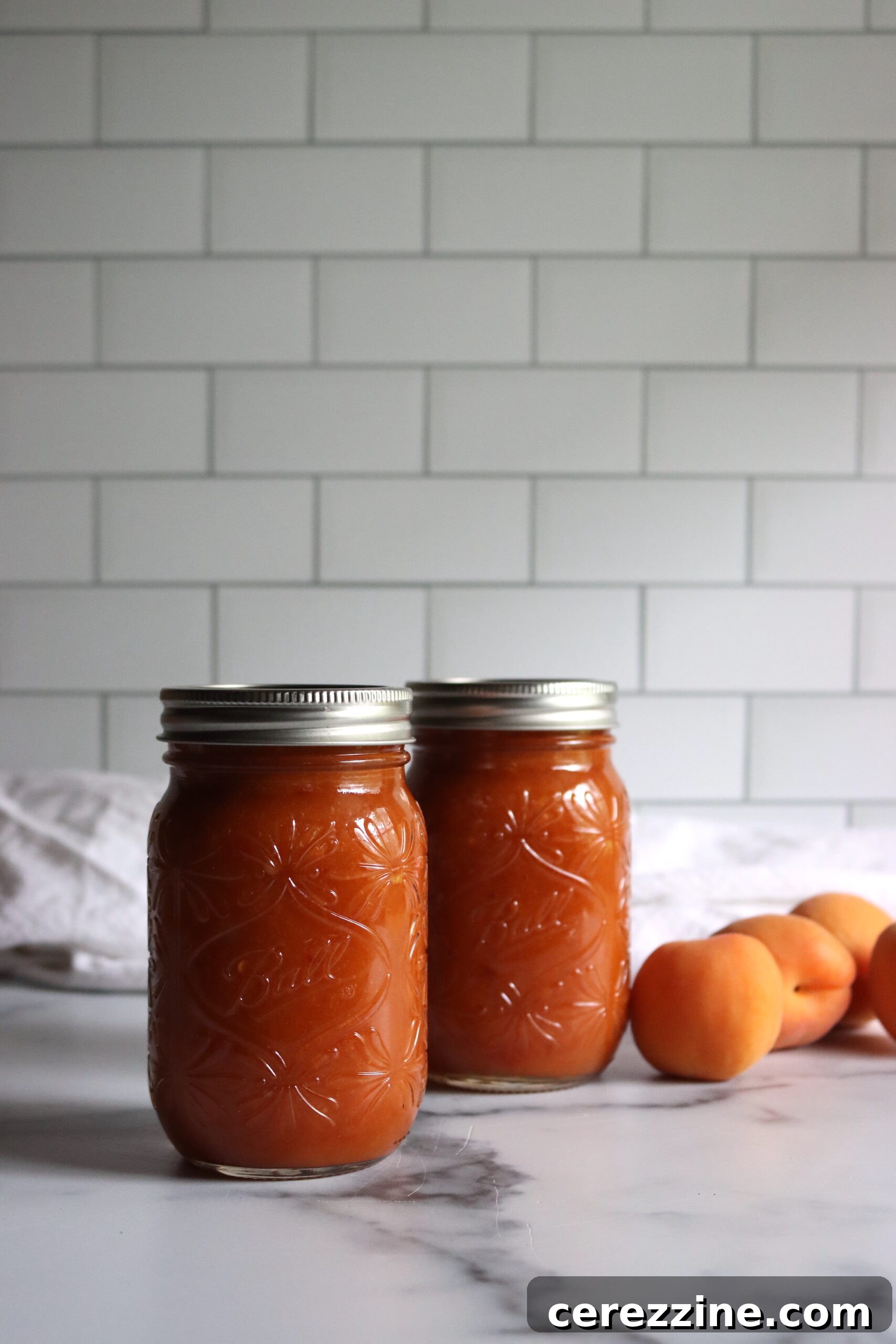 Ingredients for homemade Apricot BBQ Sauce on a wooden cutting board