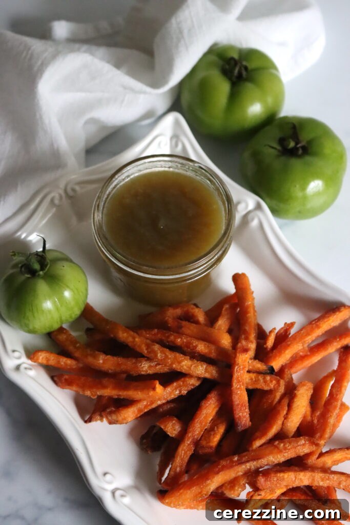 Zesty Green Tomato Ketchup 3 A bowl of vibrant green tomatoes and an onion, essential ingredients for homemade green tomato ketchup.