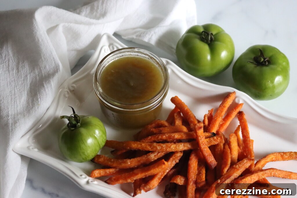 Tangy Green Tomato Ketchup 8 A serving of homemade green tomato ketchup, vibrant and appealing, in a small bowl, ready to be paired with various dishes.