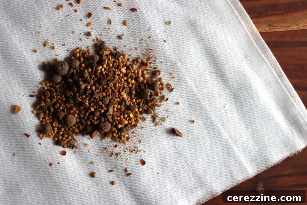 Craft Your Own Pickling Spice 4 A hand mixing various whole and ground pickling spices in a bowl
