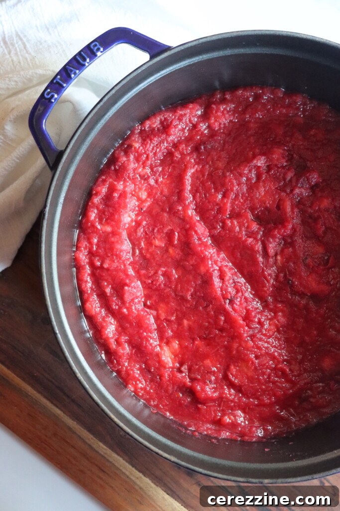 Finished crabapple sauce in a pot, after seeds and skins have been removed by a food mill.