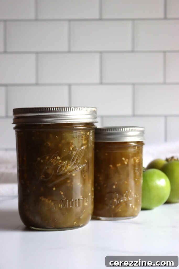 Rows of beautifully sealed jars filled with homemade Green Tomato Chow Chow, ready for the pantry, gleaming against a bright white backdrop.