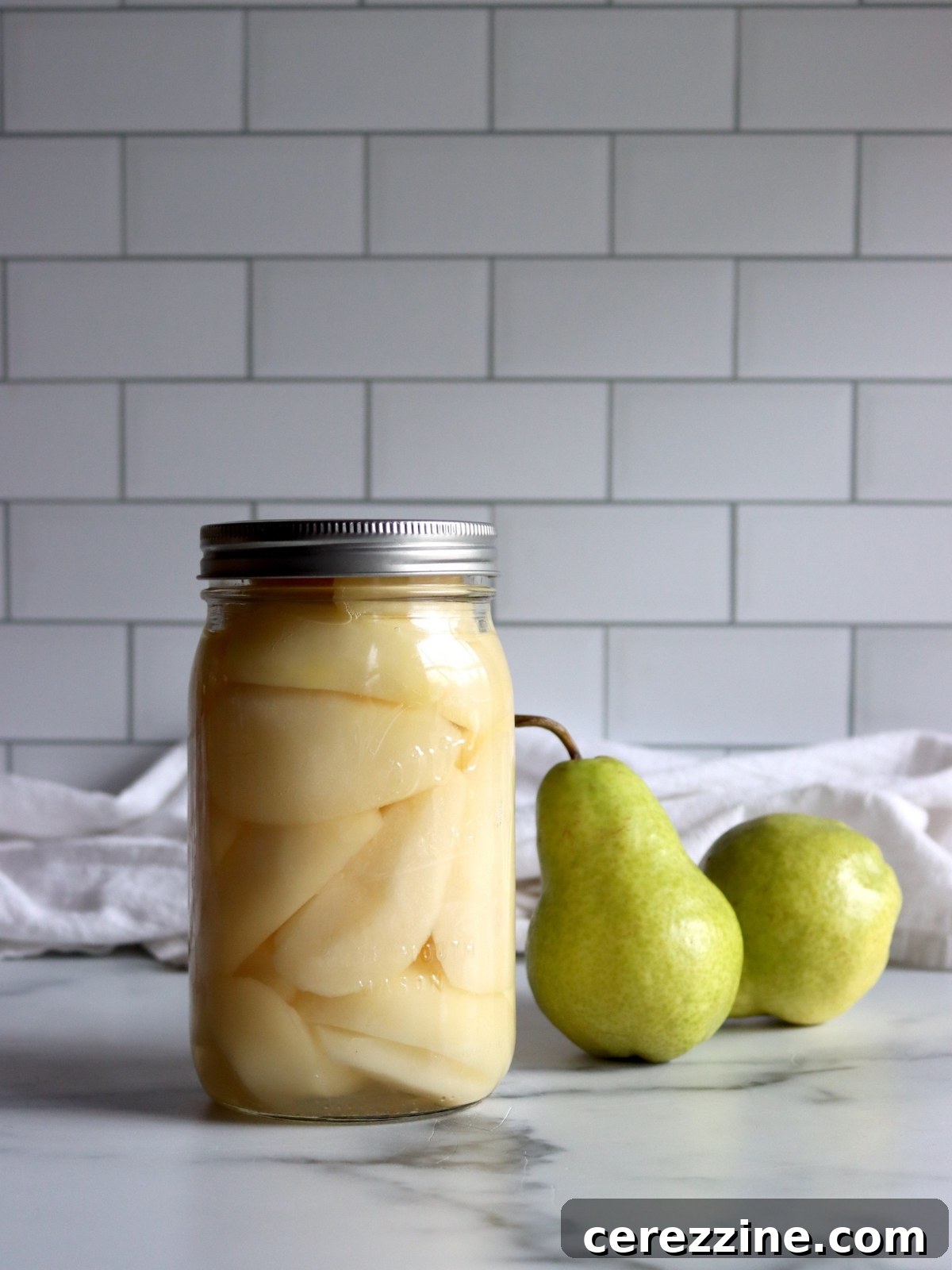 How to Can Pears - Sealed jars of canned pears on a cooling rack.