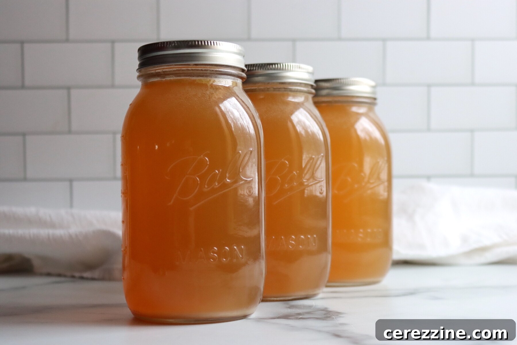 Three jars of pressure canned turkey broth.