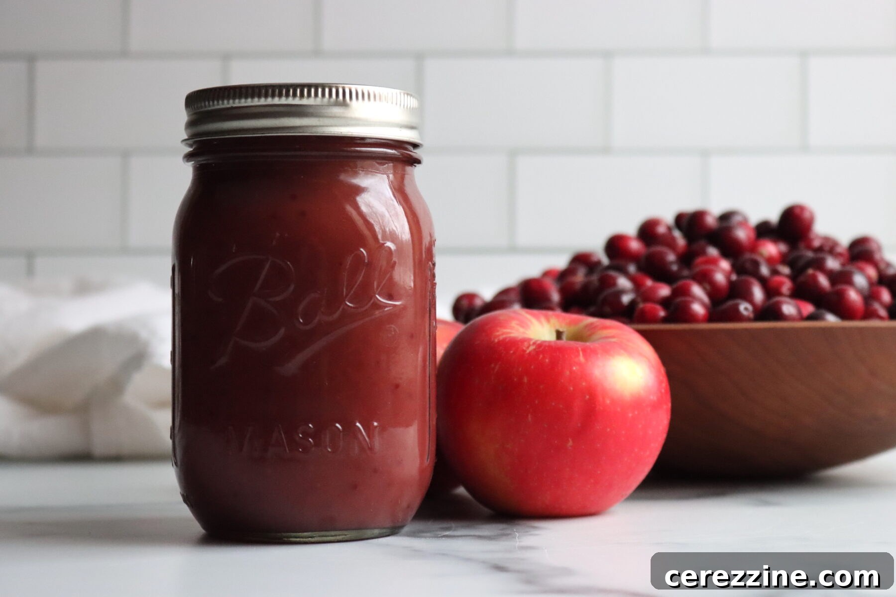 Ruby Red Cranberry Applesauce 8 Several jars of cranberry applesauce cooling on a rack