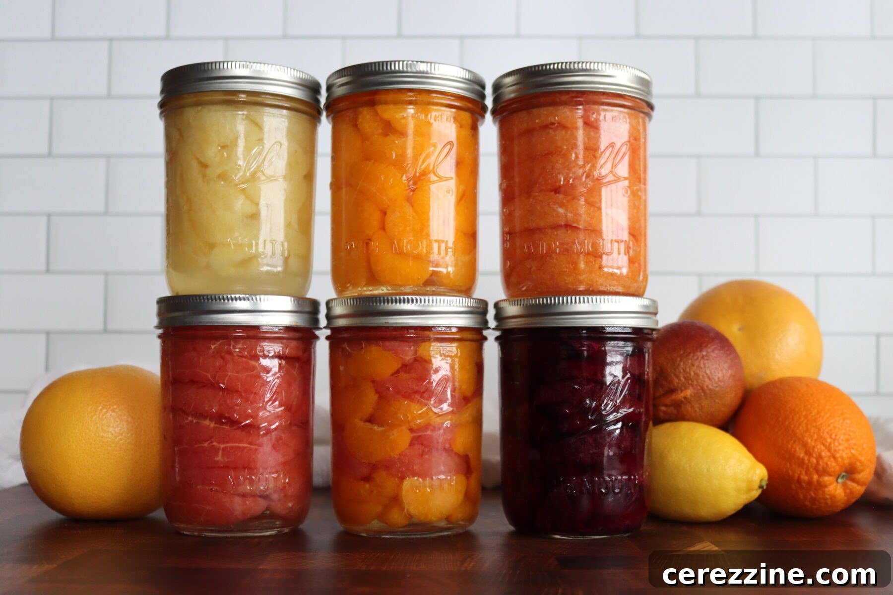 Canning Citrus Segments. First row, Candied lemon segments, orange, cara cara orange, blood orange, orange/grapefruit mix, and grapefruit.