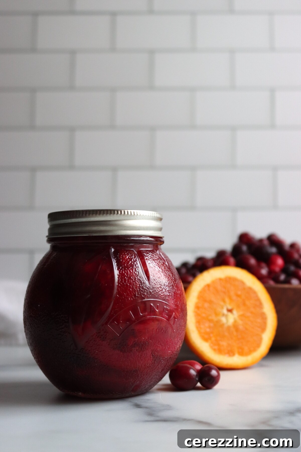 Cranberry Orange Marmalade jar and fresh cranberries