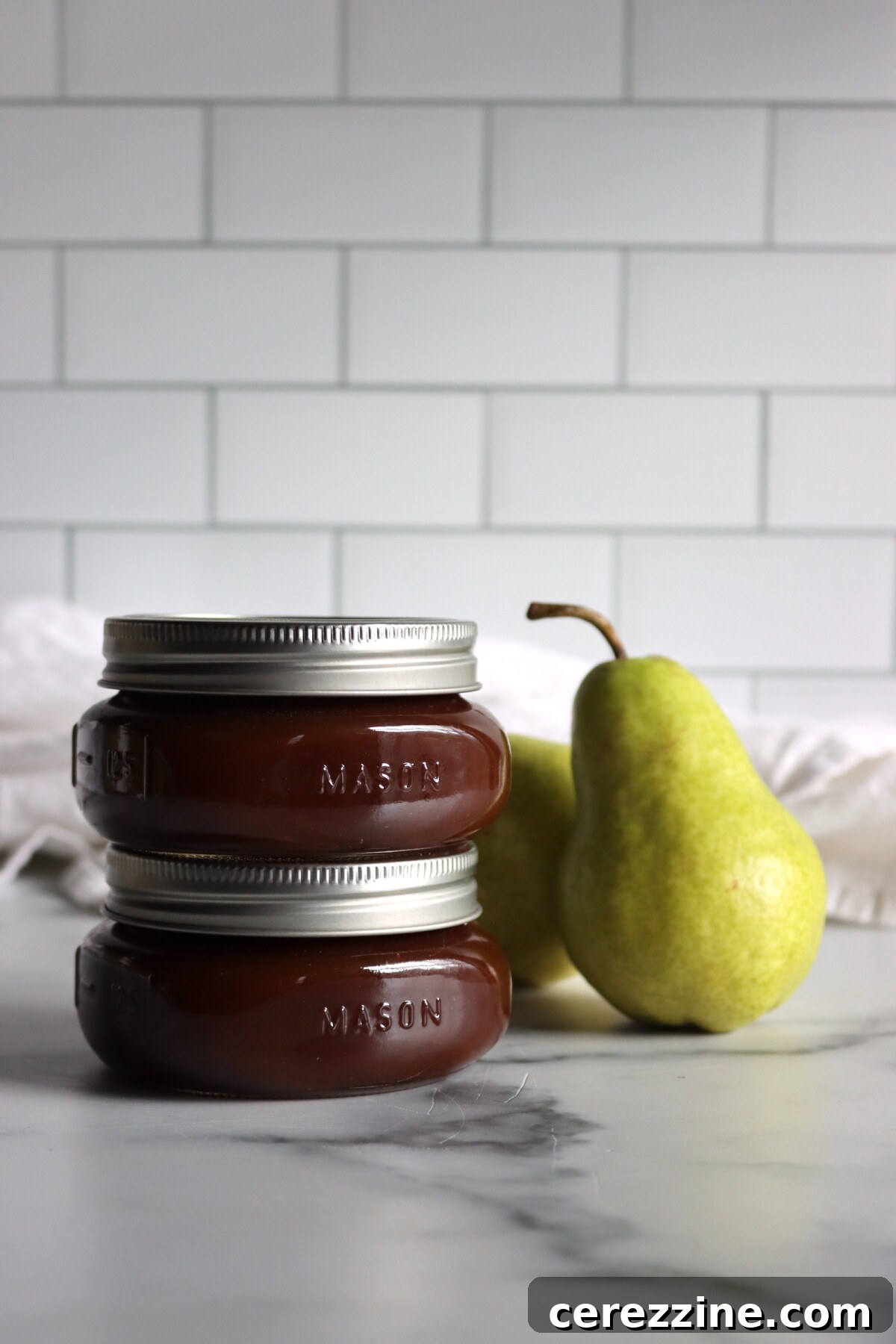 Maple Bourbon Pear Butter in glass jars.