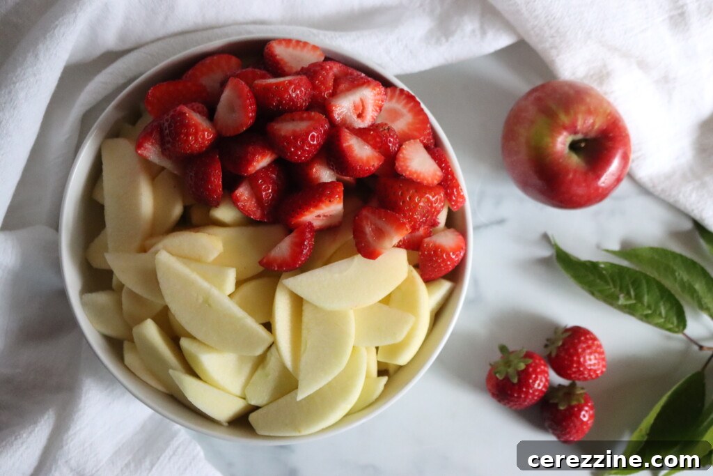 Blushing Berry Applesauce 4 Ingredients in a bowl prepared for making strawberry applesauce.