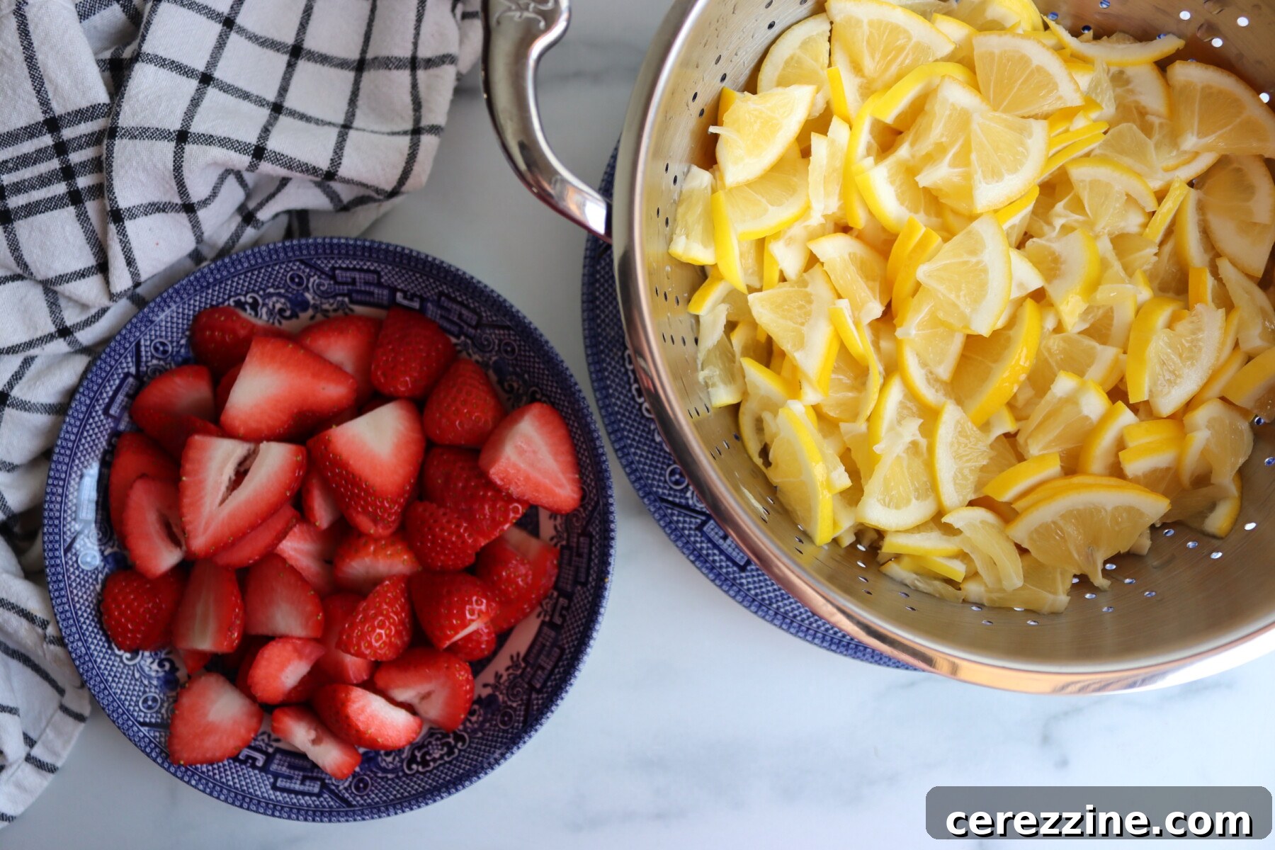 Prepared strawberries and drained lemon slices for marmalade
