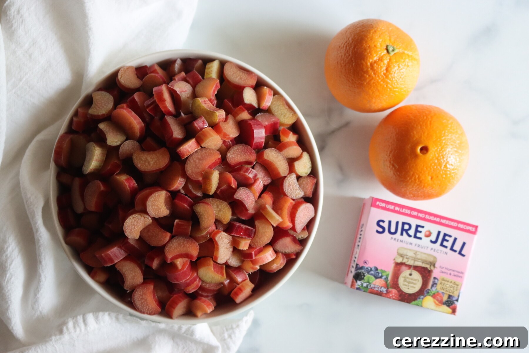 Freshly chopped rhubarb and sliced oranges ready to be made into jam.